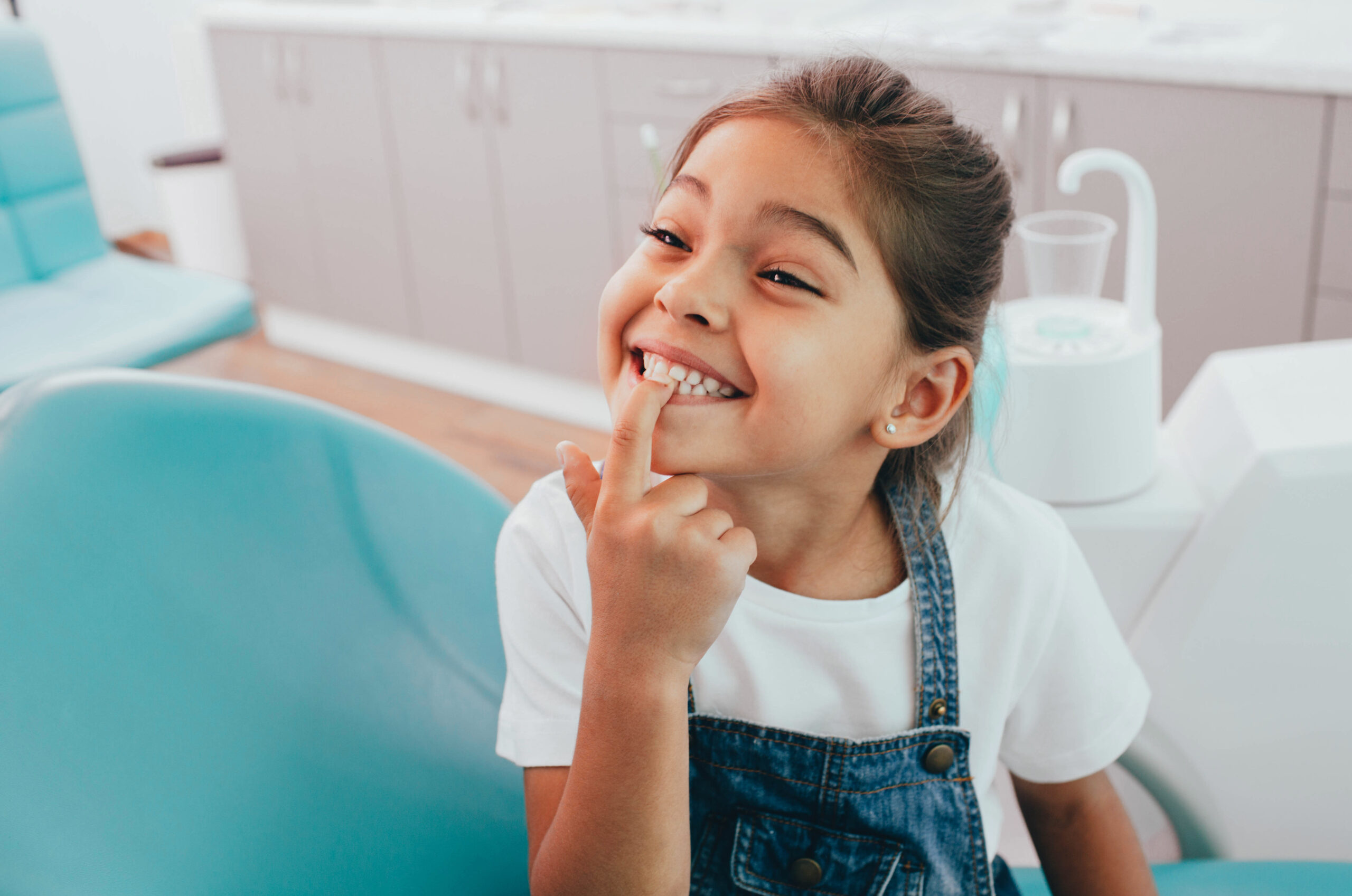 Child pointing at teeth, Dr Tisseront, Children's Orthodontics Reston, VA